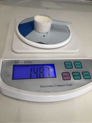Redcon 1 Total War Pre Workout Powder in scoop showing weight on scale
